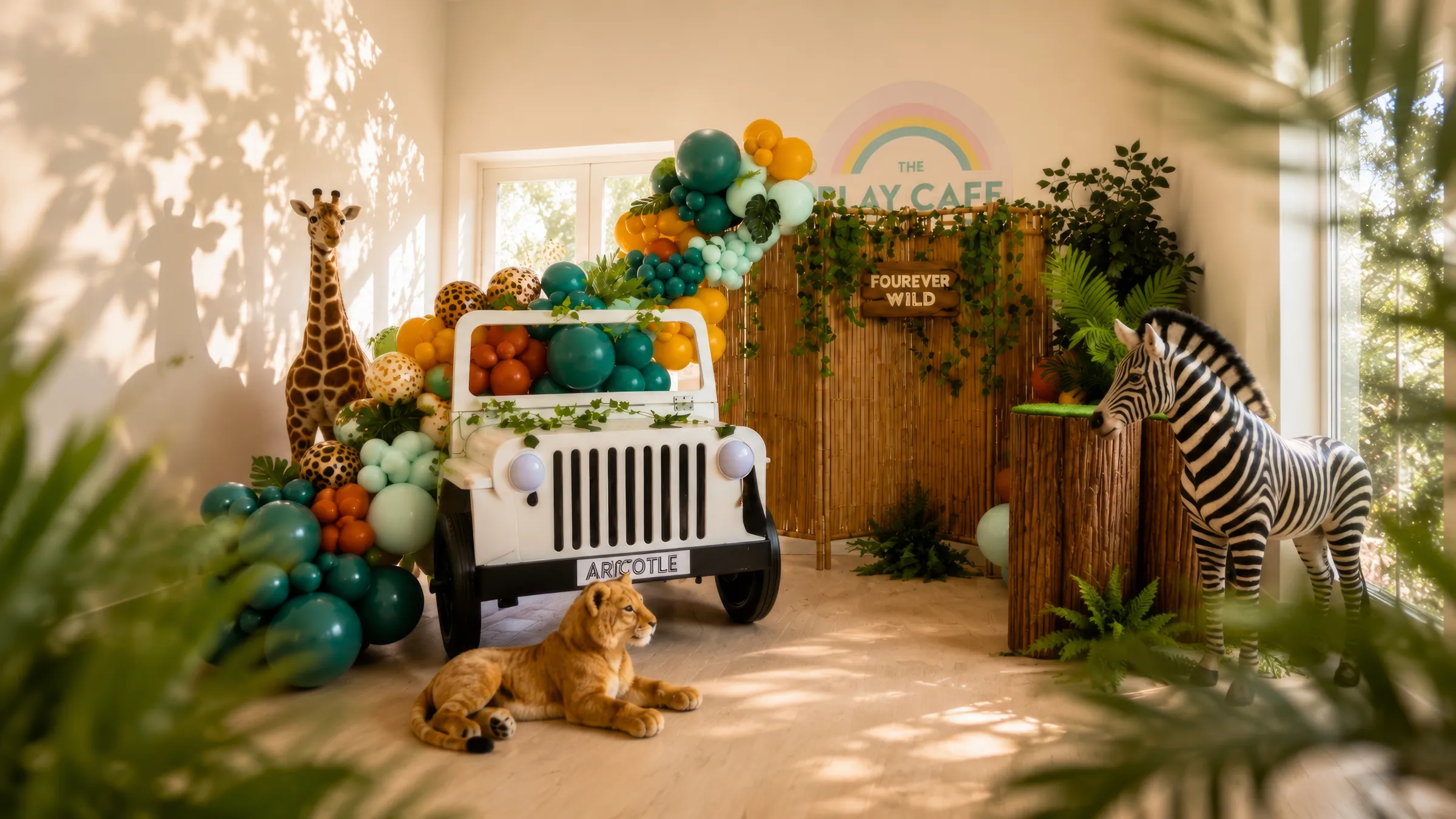 Fourever Wild jungle-theme children's party by River Fox Events - safari balloon garland, name sign and tropical foliage