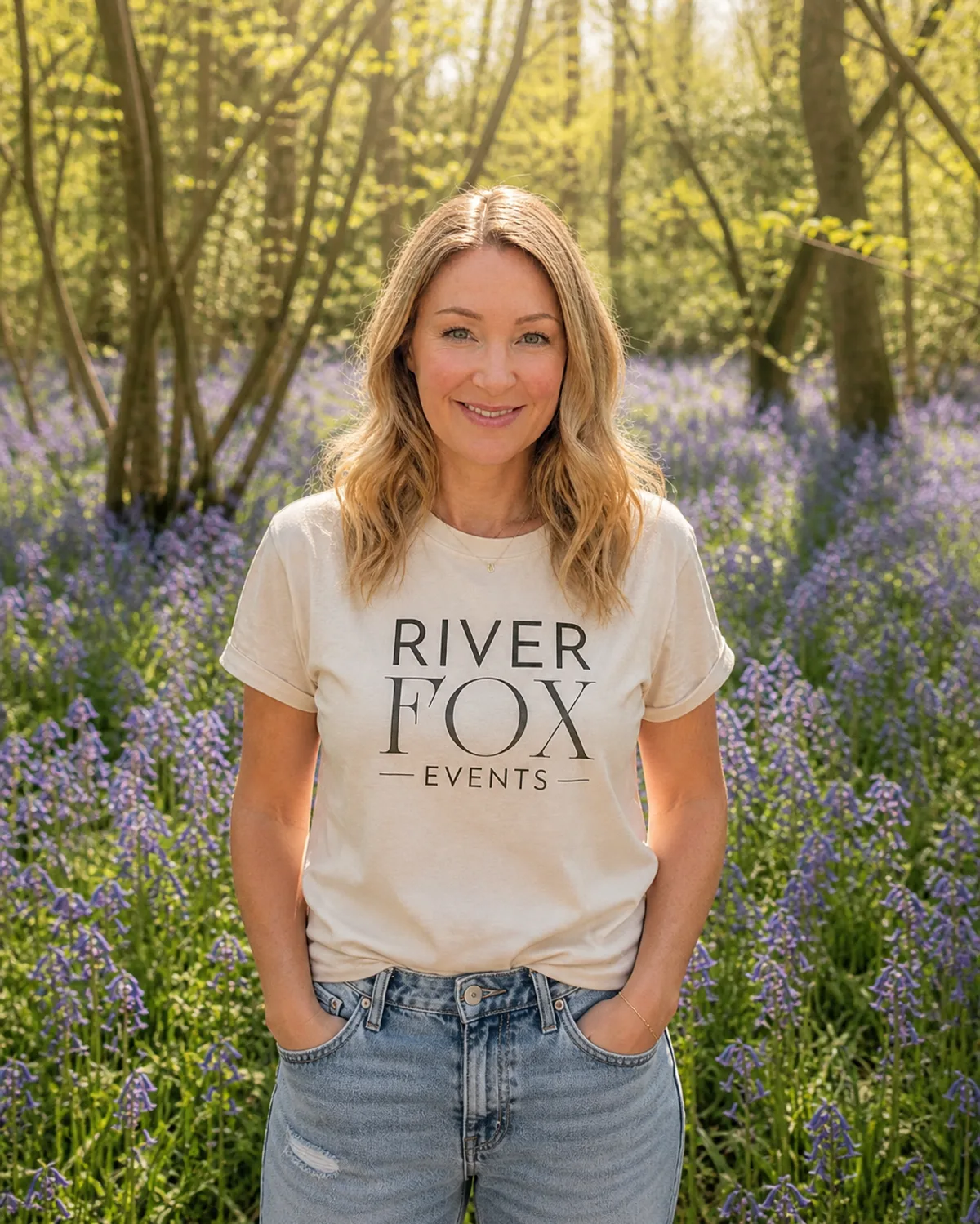 Laura, founder of River Fox Events, photographed amongst Surrey bluebells in a River Fox Events tee — luxury event stylist for children's parties, milestones and brand celebrations
