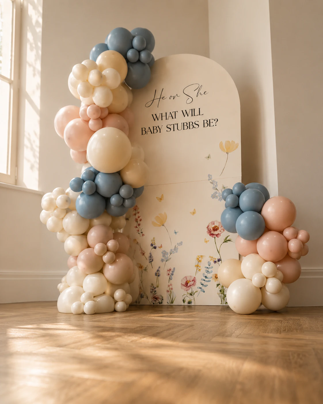 Side angle of the He or She balloon arch in soft blue and pink for the Stubbs family gender reveal by River Fox Events