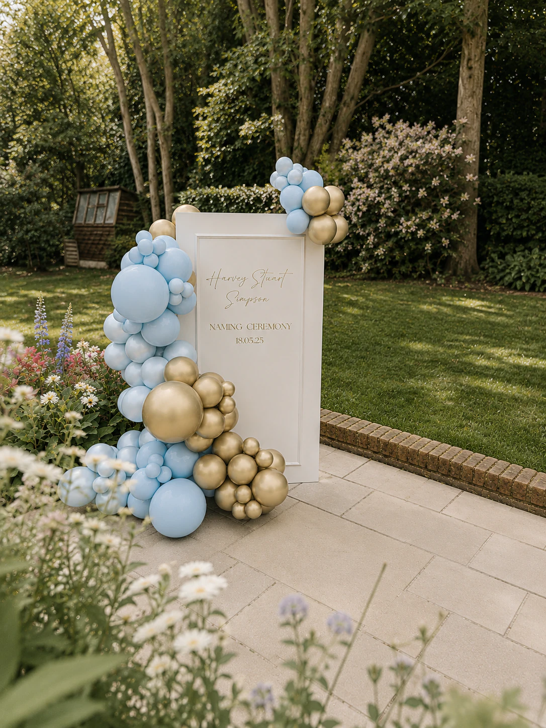 Daisies and wildflowers in the foreground of Harvey's garden naming ceremony arch styled by River Fox Events